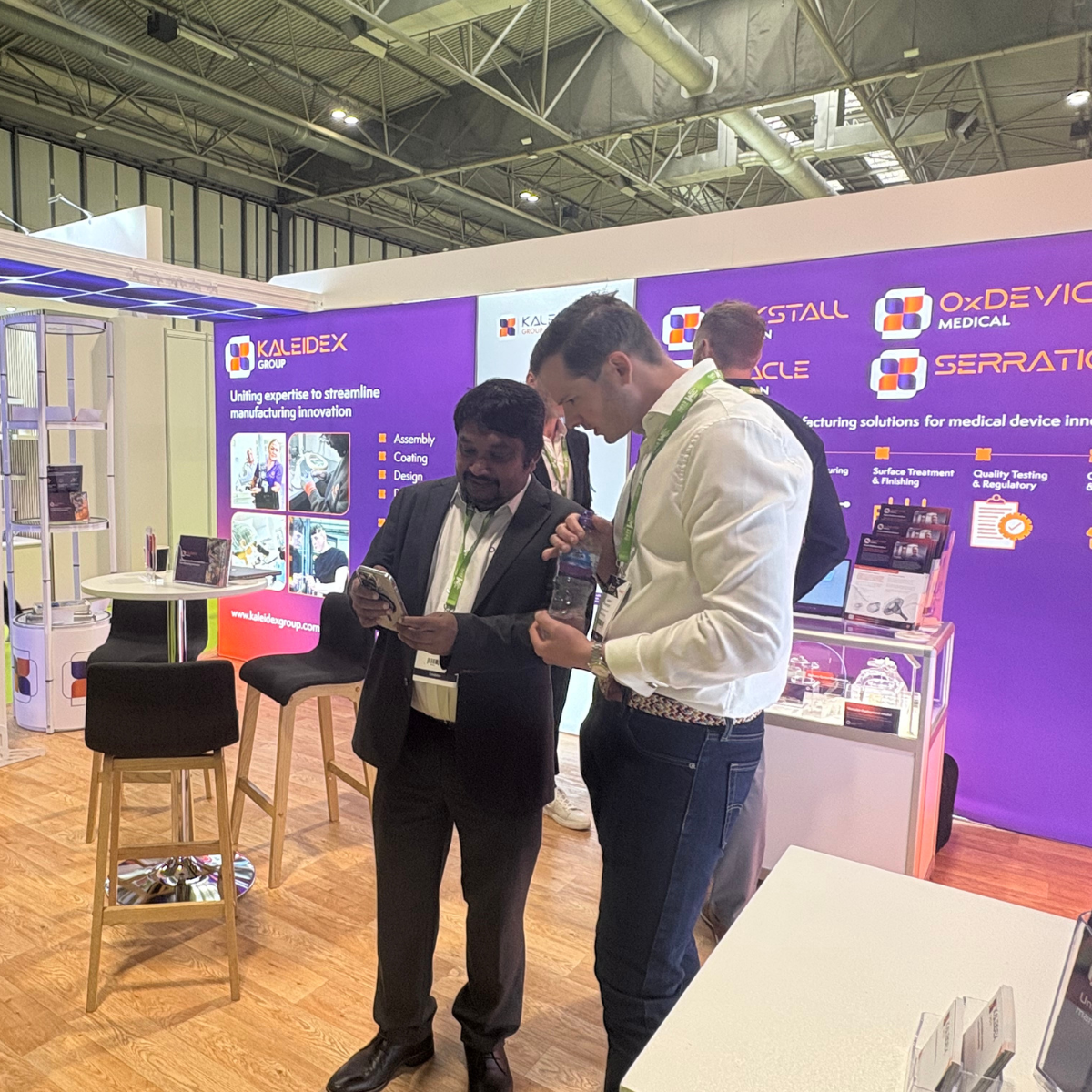 Praveen in discussion with colleagues at the Kaleidex stand